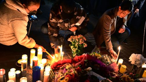 People attend a candle light vigil for victims of a mass shooting outside the City Hall in Monterey Park, California on January 23, 2023. - The 72-year-old Asian immigrant who killed 11 people on January 21, 2023, before shooting himself as police moved in on him was once a regular at the California dance club where a tragic gun massacre unfolded. (Photo by Frederic J. BROWN / AFP) (Photo by FREDERIC J. BROWN/AFP via Getty Images)