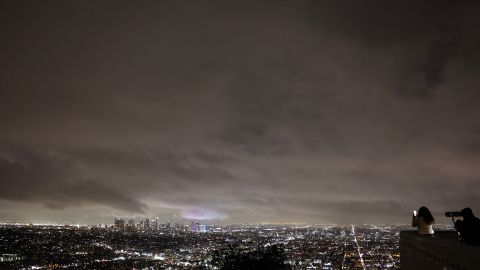 LOS ANGELES, CALIFORNIA - MARCH 28: People gather at Griffith Observatory as storm clouds pass during a late season storm on March 28, 2022 in Los Angeles, California. The storm brought much-needed rain and snow to Southern California following a mostly dry winter amid drought conditions. As of March 24th, 37 percent of California was experiencing 'extreme drought'. (Photo by Mario Tama/Getty Images)