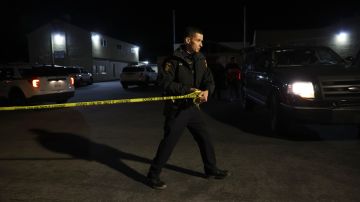 HALF MOON BAY, CALIFORNIA - JANUARY 23: A San Mateo County sheriff deputy pulls police tape across the entrance to a family reunification center following a mass shooting on January 23, 2023 in Half Moon Bay, California. Seven people were killed at two separate farm locations that were only a few miles apart in Half Moon Bay on Monday afternoon. The suspect, Chunli Zhao, was taken into custody a few hours later without incident. (Photo by Justin Sullivan/Getty Images)