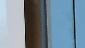 A security guard stands in position as Porter Ranch residents, seen reflected on the glass door, await entry to the SoCal Gas Community Resource Center in Porter Ranch, California on January 8, 2016, where residents have been going to lodge complaints and seek an alternative housing situation from their homes near where natural gas leaking from a well has sickened and displaced thousands of residents. More than 1,600 odor complaints have been lodged by residents with the air district since October 23, 2015 when the leak began. Repeated efforts to stop the leak by pumping liquid and mud down the well have failed and the gas company is now drilling a relief well to intercept and plug the damaged well.AFP PHOTO/FREDERIC J. BROWN / AFP / FREDERIC J. BROWN (Photo credit should read FREDERIC J. BROWN/AFP via Getty Images)