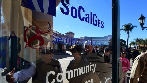 A security guard gestures the way in for Porter Ranch residents arriving at the SoCal Gas Community Resource Center in Porter Ranch, California on January 8, 2016, where residents have been going to lodge complaints and seek an alternative housing situation from their homes near where natural gas leaking from a well has sickened and displaced thousands of residents. More than 1,600 odor complaints have been lodged by residents with the air district since October 23, 2015 when the leak began. Repeated efforts to stop the leak by pumping liquid and mud down the well have failed and the gas company is now drilling a relief well to intercept and plug the damaged well.AFP PHOTO/FREDERIC J. BROWN / AFP / FREDERIC J. BROWN (Photo credit should read FREDERIC J. BROWN/AFP via Getty Images)