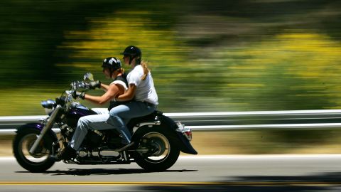 LA CANADA, CA - JUNE 21: Motorcyclists speed past roadside flowers as a heavy wildflower bloom, the result of last winter's record rainfall, continues on the first day of summer along the Angeles Crest Highway on June 21, 2005 in the Angeles National Forest northwest of La Canada, California. Last winter's rainfall is expected to be remembered as the region's second all-time rainiest season on record, coming to within one inch of being the rainiest. (Photo by David McNew/Getty Images)