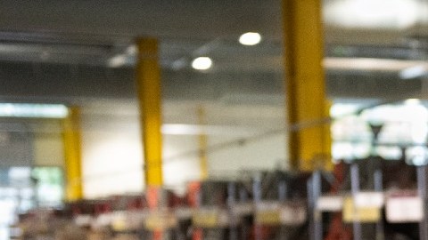 Imagen de una banda de procesamiento en la que se ven tres cajas de la empresa Amazon.