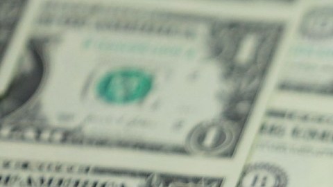 Imagen de varias impresiones de billetes de dólar.