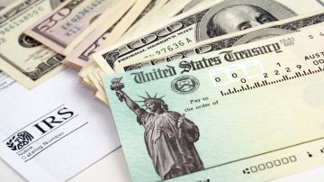 Imagen de un cheque de estímulo, un formulario de impuestos y billetes.