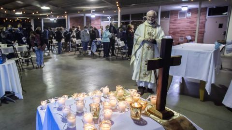 Bishop David O'Connell prays while he looks at candles placed on an altar representing people who lost their lives during the coronavirus pandemic, during a non-denominational memorial service to provide a space for community members who have lost loved ones in 2020 at the Saint Cornelius Catholic Church in Long Beach, California on November 14, 2020. - After California passed 1 million coronavirus cases a travel advisory was issued on November 13 urging a two-week quarantine for those arriving from other states or countries. (Photo by Apu GOMES / AFP) (Photo by APU GOMES/AFP via Getty Images)