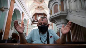 TOPSHOT - A Catholic faithful wears a face mask during the celebration of Ash Wednesday in Cali, Colombia, on February 17, 2021. - Ash Wednesday marks the Christian period of Lent, prior to the Holy Week. (Photo by Luis ROBAYO / AFP) (Photo by LUIS ROBAYO/AFP via Getty Images)