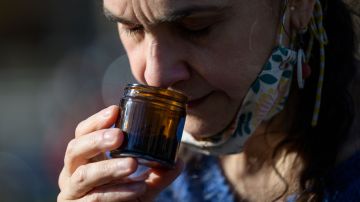 Leah Holzel, 60, food editor, smells aromatic spices during an interview with AFP on March 22, 2021 in New York City. - Holzel, who had lost her sense of smell from 2016 to 2019, now coaches people who have lost their sense of smell due to Covid-19 and has helped six people recover from anosmia since the start of the pandemic. (Photo by Angela Weiss / AFP) (Photo by ANGELA WEISS/AFP via Getty Images)
