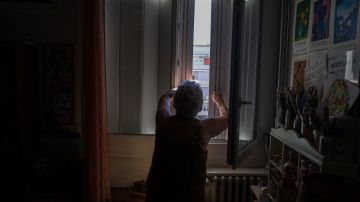 Jackye Lafon, an 81-year-old retiree, closes the shutters of her flat in the Cite Bourbaki in the Minimes district of Toulouse on July 14, 2022. - France is witnessing a second heatwave in less than a month, "a sign of climate change and hotter summers to come where 35 degrees will be the norm" said the French weather broadcast company Meteo France. (Photo by FRED SCHEIBER / AFP) (Photo by FRED SCHEIBER/AFP via Getty Images)