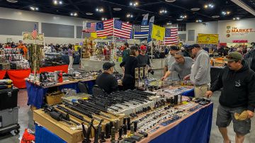 Men browse as vendors sell firearms and accessories at the Crossroads of the West Gun Show at the Convention Center in Ontario, California, on January 28, 2023. - The Gun Show is located 32 miles away from the Star Ballroom Dance Studio, the site of the mass shooting that took the lives of 11 people and injured 10 others during the Lunar New Year's Eve in Monterey, California. (Photo by Apu GOMES / AFP) (Photo by APU GOMES/AFP via Getty Images)