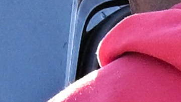 A Los Angeles Police Department (LAPD) officer wears an Axon body camera (R) as a Black driver is handcuffed and placed into a patrol car during a traffic stop by officers on Crenshaw Blvd in Los Angeles, California on January 31, 2023. (Photo by Patrick T. Fallon / AFP) (Photo by PATRICK T. FALLON/AFP via Getty Images)