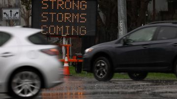 SAUSALITO, CALIFORNIA - JANUARY 07: Cars drive by a sign warning of storms hitting the Bay Area on January 07, 2023 in Sausalito, California. The San Francisco Bay Area continues to get drenched by powerful atmospheric river events that have brought high winds and flooding rains. The storms have toppled trees, flooded roads and cut power to tens of thousands. Storms are lined up over the Pacific Ocean and are expected to bring more rain and wind through next week. (Photo by Justin Sullivan/Getty Images)