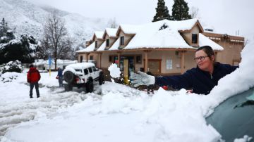 GREEN VALLEY, CALIFORNIA - FEBRUARY 25: A person clears snow from their windshield in Los Angeles County, in the Sierra Pelona Mountains, on February 25, 2023 in Green Valley, California. A major storm, carrying a rare blizzard warning for parts of Southern California, is delivering heavy snowfall to the mountains with some snowfall expected to reach lower elevations in Los Angeles County. The National Weather Service has called the storm 'one of the strongest ever' to impact southwest California as it has also delivered widespread heavy rains and high winds. (Photo by Mario Tama/Getty Images)