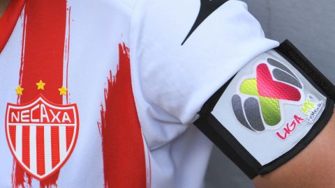 Escudo del club Rayos del Necaxa en su popular playera rojiblanca.