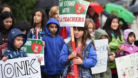 Students pose for a snapshot after walking the picket line with their teachers and parents on the third day of the teachers' strike, January 16, 2019, outside Dahlia Heights Elementary School in the Eagle Rock section of Los Angeles, California. - Teachers of the Los Angeles Unified School District (LAUSD), the second largest public school district in the United States, are striking for smaller class size, better school funding and higher teacher pay. (Photo by Robyn Beck / AFP) (Photo credit should read ROBYN BECK/AFP via Getty Images)