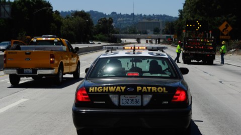LOS ANGELES, CA - JULY 17: A California Highway Patrol cruiser waits to lead motorist on as construction workers remove barricades on the southbound Interstate 405 freeway before it re-opened ahead of schedule following a 10-mile shutdown of the freeway for bridge work on July 17, 2011 in Los Angeles, California. Los Angeles city officials advised residents to stay home or stay away from the area over the weekend fearing massive traffic jams of what has become known as "Carmageddon." which never materialized. (Photo by Kevork Djansezian/Getty Images)