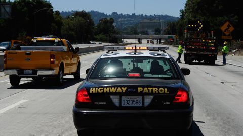 LOS ANGELES, CA - JULY 17: A California Highway Patrol cruiser waits to lead motorist on as construction workers remove barricades on the southbound Interstate 405 freeway before it re-opened ahead of schedule following a 10-mile shutdown of the freeway for bridge work on July 17, 2011 in Los Angeles, California. Los Angeles city officials advised residents to stay home or stay away from the area over the weekend fearing massive traffic jams of what has become known as "Carmageddon." which never materialized. (Photo by Kevork Djansezian/Getty Images)