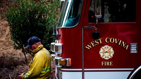 West covina firefighters rest on their fire truck as the Bobcat Fire burns in the San Gabriel mountains above Monrovia, California on September 16, 2020. - California faces more devastation from wildfires that have ravaged the West Coast, authorities warned on September 16, with strong winds and dry heat expected to whip up flames from dozens of blazes raging across the state. (Photo by RINGO CHIU / AFP) (Photo by RINGO CHIU/AFP via Getty Images)