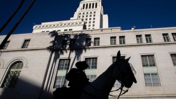 LOS ANGELES, CA - JANUARY 20: A police officer in a horse patrol stands in front of the Los Angeles City Hall on January 20, 2021 in Los Angeles, California. During today's inauguration ceremony, Joe Biden becomes the 46th president of the United States. (Photo by Apu Gomes/Getty Images)