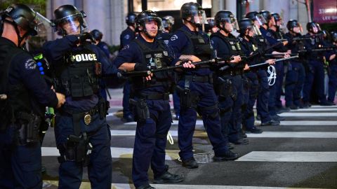 Police officers holding batons and rubber-bullet guns prepare to disperse a crowd of abortion rights activists protesting after the overturning of Roe Vs. Wade by the US Supreme Court, in Downtown Los Angeles, on June 24, 2022. - The US Supreme Court on Friday struck down the right to abortion in a seismic ruling that shredded five decades of constitutional protections and prompted several right-leaning states to impose immediate bans on the procedure. (Photo by Frederic J. BROWN / AFP) (Photo by FREDERIC J. BROWN/AFP via Getty Images)