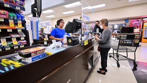 People stand at the check-out counter after shopping at a grocery supermarket in Alhambra, California, on July 13, 2022. - US consumer price inflation surged 9.1 percent over the past 12 months to June, the fastest increase since November 1981, according to government data released on July 13. Driven by record-high gasoline prices, the consumer price index jumped 1.3 percent in June, the Labor Department reported. (Photo by Frederic J. BROWN / AFP) (Photo by FREDERIC J. BROWN/AFP via Getty Images)