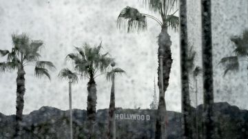 The Hollywood sign is seen through raindrops on a window in Hollywood, California, on January 10, 2023. (Photo by Stefani Reynolds / AFP) (Photo by STEFANI REYNOLDS/AFP via Getty Images)