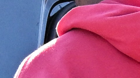 A Los Angeles Police Department (LAPD) officer wears an Axon body camera (R) as a Black driver is handcuffed and placed into a patrol car during a traffic stop by officers on Crenshaw Blvd in Los Angeles, California on January 31, 2023. (Photo by Patrick T. Fallon / AFP) (Photo by PATRICK T. FALLON/AFP via Getty Images)
