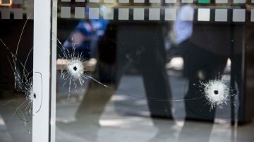 Picture of bullet holes in a window of a supermarket belonging to the family of Antonela Roccuzzo, the wife of Argentine football star Lionel Messi, after attackers fired shots at the facade of the closed premises early in the morning and left a threat message to Messi, in Rosario, Santa Fe Province, Argentina, on March 2, 2023. - Two men attacked the front of a supermarket belonging to the in-laws of Messi and left a written message mentioning the captain of the world champion Argentine team, the mayor of the city Pablo Javkin said. "Messi we are waiting for you. Javkin is a narco, he will not protect you" the handwritten message said. (Photo by AFP) (Photo by STR/AFP via Getty Images)