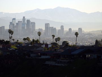 Palm trees stand above homes on the skyline in front of downtown Los Angeles after sunrise following heavy rain from winter storms, as seen from the Kenneth Hahn State Recreation Area, on March 2, 2023, in Los Angeles, California. (Photo by Patrick T. Fallon / AFP) (Photo by PATRICK T. FALLON/AFP via Getty Images)