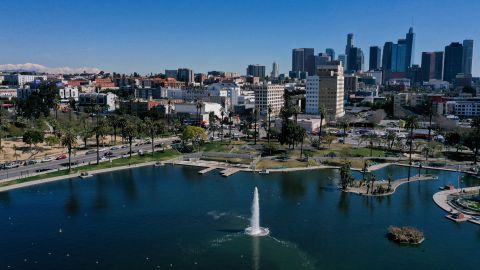 An aerial image shows snow capped mountains on the horizon with the downtown Los Angeles skyline following heavy rain from winter storms as seen above MacArthur Park on March 2, 2023 in Los Angeles, California. (Photo by Patrick T. Fallon / AFP) (Photo by PATRICK T. FALLON/AFP via Getty Images)