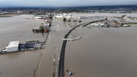 This aerial photograph shows floodwaters submerging the road to enter Pajaro, California, on March 11, 2023. - Residents were forced to evacuate in the middle of the night after an atmospheric river surge broke the the Pajaro Levee and sent flood waters flowing into the community. (Photo by JOSH EDELSON / AFP) (Photo by JOSH EDELSON/AFP via Getty Images)