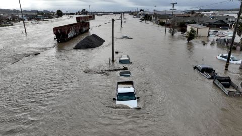 This aerial photograph shows train cars, vehicles and homes in floodwaters in Pajaro, California on Saturday, March 11, 2023. - Residents were forced to evacuate in the middle of the night after an atmospheric river surge broke the the Pajaro Levee and sent flood waters flowing into the community. (Photo by JOSH EDELSON / AFP) (Photo by JOSH EDELSON/AFP via Getty Images)