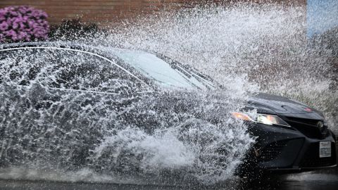 A car drives in the rain through storm water during a winter storm Los Angeles, California, on March 14, 2023. (Photo by Patrick T. Fallon / AFP) (Photo by PATRICK T. FALLON/AFP via Getty Images)