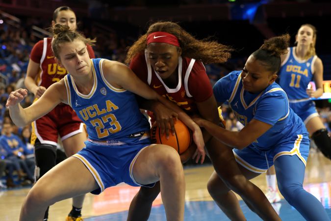 LOS ANGELES, CALIFORNIA - JANUARY 08: Gabriela Jaquez #23 of the UCLA Bruins, Okako Adika #24 of the USC Trojans, and Londynn Jones #3 of the UCLA Bruins fight for control of the ball during the second half of a game at UCLA Pauley Pavilion on January 08, 2023 in Los Angeles, California. (Photo by Katharine Lotze/Getty Images)
