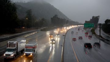 LOS ANGELES, CALIFORNIA - FEBRUARY 24: Vehicles drive through winter storm rains on Interstate 5 on February 24, 2023 in Los Angeles, California. A major storm, carrying a rare blizzard warning for parts of Southern California, has begun to deliver heavy snowfall to the mountains with some snowfall expected to reach lower elevations in Los Angeles County. Los Angeles is also seeing widespread heavy rains from the storm. (Photo by Mario Tama/Getty Images)