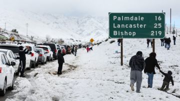 ACTON, CALIFORNIA - FEBRUARY 26: Cars are lined up after people parked on the side of the freeway to walk and play in the snow along Highway 14 in Los Angeles County on February 26, 2023 near Acton, California. A major storm, which carried a rare blizzard warning for parts of Southern California, delivered heavy snowfall to the mountains with some snowfall reaching lower elevations in Los Angeles County. The National Weather Service called the storm 'one of the strongest ever' to impact southwest California as it also delivered widespread heavy rains and high winds. Southern California snowfall topped out at 6 feet at Mountain High with rain topping five inches at Cucamonga Canyon. (Photo by Mario Tama/Getty Images)