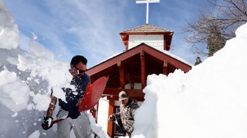 TWIN PEAKS, CALIFORNIA - MARCH 08: Residents shovel snow from in front of a church after a series of winter storms dropped more than 100 inches of snow in the San Bernardino Mountains in Southern California on March 8, 2023 in Twin Peaks, California. According to the San Bernardino County Board of Supervisors, three people have been found dead after official welfare checks in the mountains since the historic storms began. Some residents were stranded in the area for more than ten days due to the snowfall while running low on food, supplies and medicine. (Photo by Mario Tama/Getty Images)