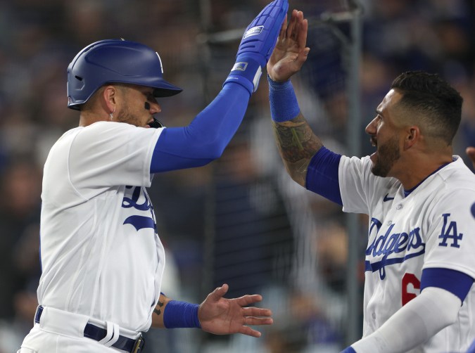 LOS ANGELES, CALIFORNIA - MARCH 30: Miguel Rojas #11 of the Los Angeles Dodgers celebrates his run with David Peralta #6, to tie the game 2-2 with the Arizona Diamondbacks during the third inning on opening day of the 2023 Major League Baseball season at Dodger Stadium on March 30, 2023 in Los Angeles, California. (Photo by Harry How/Getty Images)