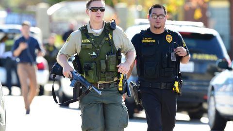 Police at the scene of a shooting on December 2, 2015 in San Bernardino, California. One or more gunman opened fire inside a building in San Bernardino in California, with reports of 20 victims at a center that provides services for the disabled. Police were still hunting for the shooter, saying one to three possible suspects were involved. Heavily armed SWAT teams, firefighters and ambulances swarmed the scene, located about an hour east of Los Angeles, as police warned residents away. AFP PHOTO / FREDERIC J. BROWN / AFP / FREDERIC J. BROWN (Photo credit should read FREDERIC J. BROWN/AFP via Getty Images)