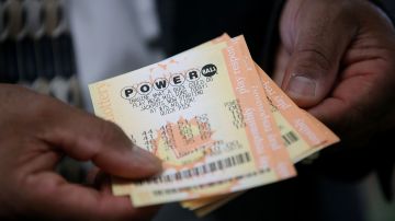 SAN LORENZO, CA - JANUARY 12: A customer holds Powerball tickets that he purchased at Kavanagh Liquors on January 12, 2015 in San Lorenzo, California. Dozens of people lined up outside of Kavanagh Liquors, a store that has had several multi-million dollar winners, to -purchase Powerball tickets in hopes of winning the estimated record-breaking $1.5 billion dollar jackpot. (Photo by Justin Sullivan/Getty Images)