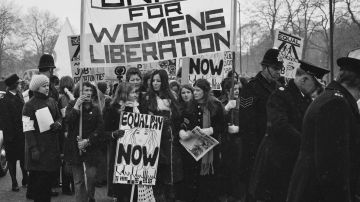 Members of the National Women's Liberation Movement, on an equal rights march from Speaker's Corner to No.10 Downing Street, to mark International Women's Day, London, 6th March 1971. One woman is carrying a placard reading 'Equal Pay Now'. On the right, a woman is holding a copy of the Trotskyist publication 'Red Mole'. (Photo by Daily Express/Hulton Archive/Getty Images)