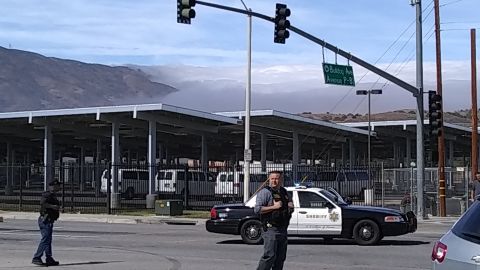 People wait at an intersection May 11, 2018 following reports of shooting at Highland High School in Palmdale, 40 miles (65 kilometers) north of downtown Los Angeles. - Police in California arrested a man after reports of shootings at two schools near Los Angeles, the local sheriff's department and education officials said. The Los Angeles County Sheriff said one suspect had been detained "regarding the person with a gun" at Highland High School. Local news reports had earlier said that at least one person had been wounded. It was not immediately clear what type of weapon the man had. (Photo by Frederic J. BROWN / AFP) (Photo credit should read FREDERIC J. BROWN/AFP via Getty Images)