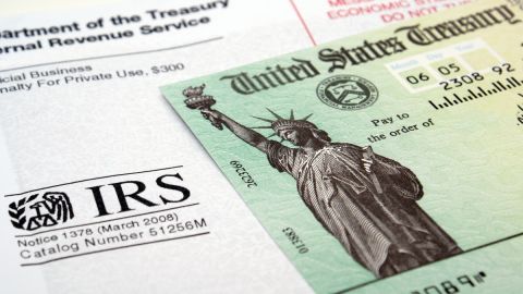 Imagen de un cheque de reembolso de impuestos y de un sobre del IRS.