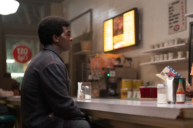 George Foreman (Khris Davis) at the counter of the OST Cafe talks with Nancy Foreman (Sonja Sohn).