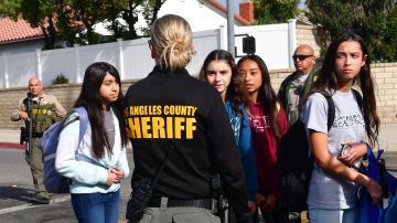 Students are directed to buses by a Los Angeles Couty Sheriff's Department officer after a shooting at Saugus High School in Santa Clarita, California on November 14, 2019. - A teenager shot dead two fellow students and wounded three others on his sixteenth birthday at a high school north of Los Angeles, before turning the gun on himself and being taken into custody still alive. (Photo by Frederic J. BROWN / AFP) (Photo by FREDERIC J. BROWN/AFP via Getty Images)