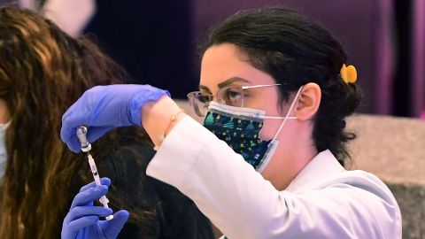 A pharmacist loads a syringe with the Covid-19 vaccine for administration at a pop-up clinic offering free vaccinations and booster shots in the international arrivals area of Los Angeles International Airport in Los Angeles on December 22, 2021. - The clinic at the airport offers free vaccinations and boosters for holiday travelers on December 22 and on December 29. Los Angeles County sees what could be the beginning of a winter surge with more than 3,200 Covid-19 cases reported every day since last December 17. (Photo by Frederic J. BROWN / AFP) (Photo by FREDERIC J. BROWN/AFP via Getty Images)