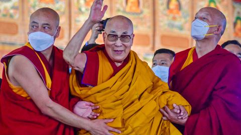 TOPSHOT - Tibetan spiritual leader Dalai Lama waves during his first day of teaching session at the Kalachakra Ground in Bodhgaya on December 29, 2022. (Photo by Sanjay KUMAR / AFP) (Photo by SANJAY KUMAR/AFP via Getty Images)