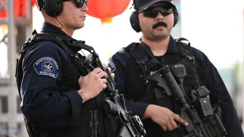 Monterey Park police officers stand at the scene of a mass shooting in Monterey Park, California, on January 22, 2023. - Ten people have died and at least 10 others have been wounded in a mass shooting in a largely Asian city in southern California, police said, with the suspect still at large hours later. (Photo by Robyn BECK / AFP) (Photo by ROBYN BECK/AFP via Getty Images)