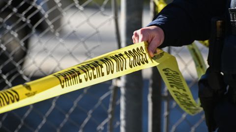 A San Mateo County Sheriff officer puts up police tape at a crime scene after a shooting at the Spanish Town shops in Half Moon Bay, California, on January 24, 2023. - A suspected gunman was in custody Monday over the killing of seven people in a rural community in northern California, just two days after a mass shooting at a Lunar New Year celebration near Los Angeles. (Photo by Samantha Laurey / AFP) (Photo by SAMANTHA LAUREY/AFP via Getty Images)