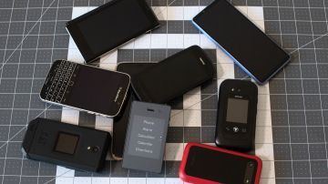 Jose Brioness Light Phone 2 (C), which he refers to as a dumbphone, is surrounded by smartphones that he discountinued using in 2019, at his apartment in Littleton, Colorado, on March 24, 2023. - Briones, 27, decided to stop using a smartphone in 2019, and instead uses what he refers to as a dumbphone, a change he felt was necessary to become more independent and less reliant on technology, resulting in a more simple and happier lifestyle. (Photo by Jason Connolly / AFP) (Photo by JASON CONNOLLY/AFP via Getty Images)